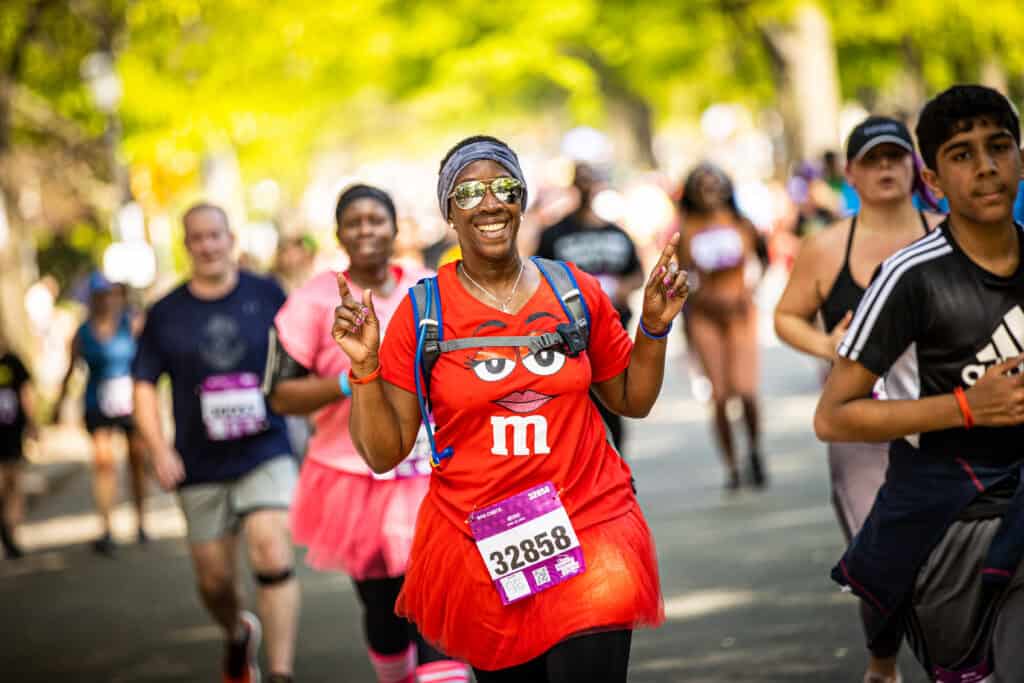 Woman runs the Ukrop's Monument Avenue 10k dressed as a red M&M's candy.