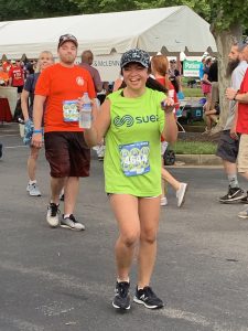 Jessica Jocson of SUEZ smiling and holding a bottle of water in the 2019 Anthem Corporate Run