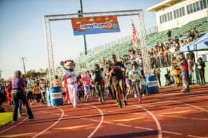 Photo of participants running at the start of the Marathon Jr. youth running event