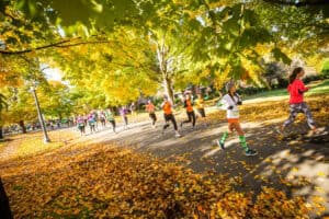 People taking part in a race in Richmond, Virginia, on a tree-lined street