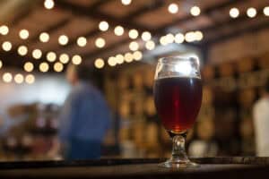 A photo of a glass of beer resting on a table at Hardywood Park Craft Brewery