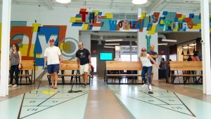 Photo of people playing shuffleboard at Tang & Biscuit bar in Scott's Addition area of Richmond, Virginia